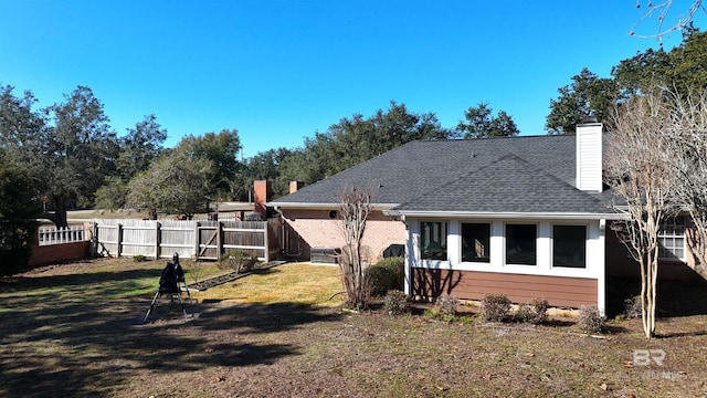 rear view of property with a yard