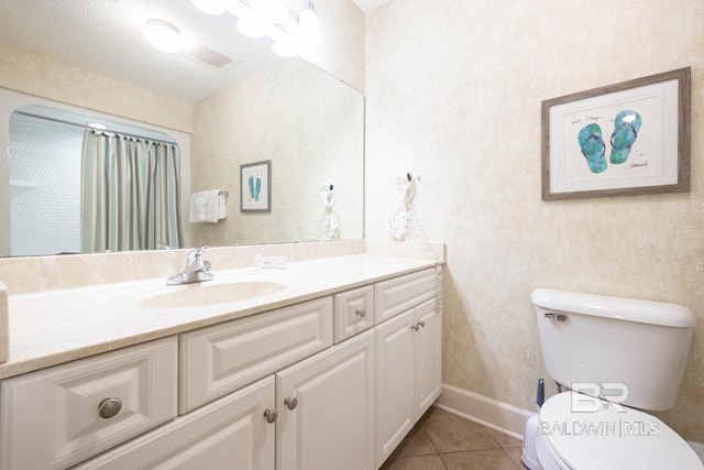 bathroom with tile patterned floors, vanity, and toilet