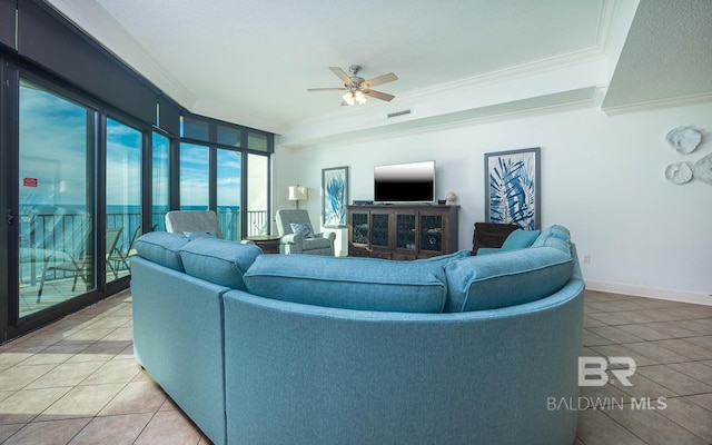 tiled living room with ceiling fan and ornamental molding