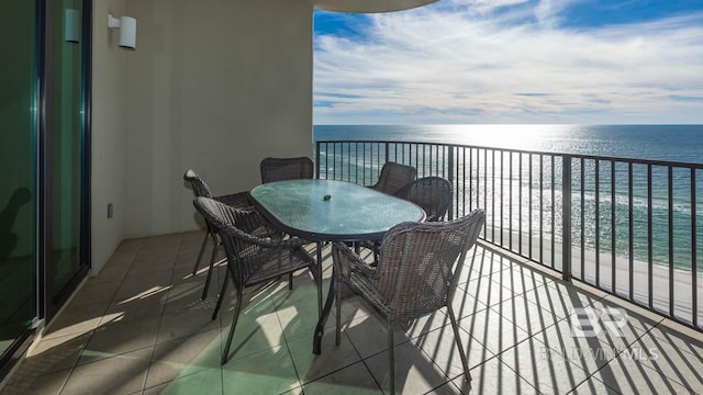 balcony featuring a water view and a view of the beach