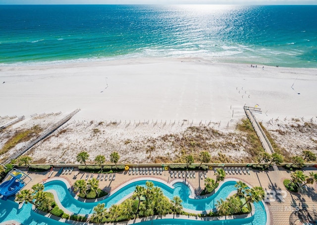 birds eye view of property with a beach view and a water view