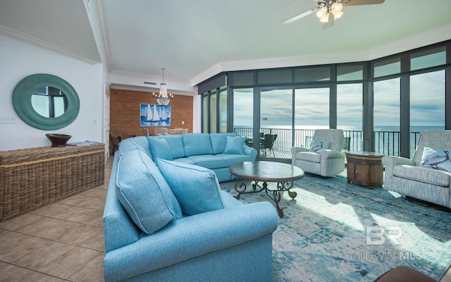 living room with tile patterned floors, ceiling fan, a water view, and ornamental molding