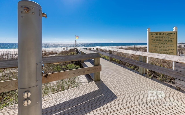 view of property's community with a beach view and a water view