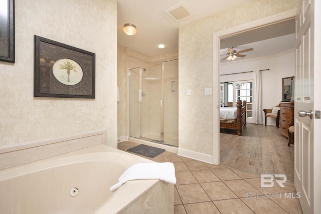 bathroom featuring ceiling fan, tile patterned flooring, plus walk in shower, and crown molding