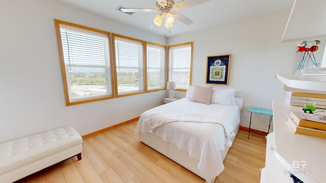 bedroom with ceiling fan and light hardwood / wood-style floors