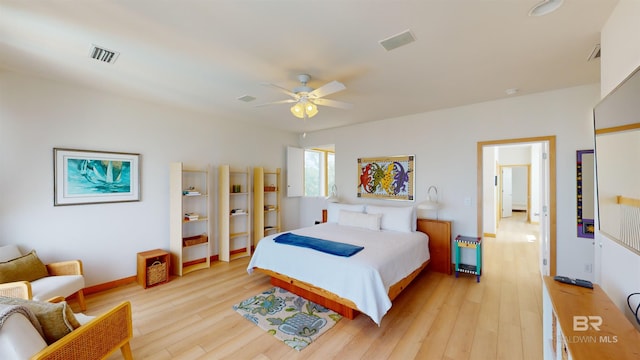 bedroom with ceiling fan and light wood-type flooring