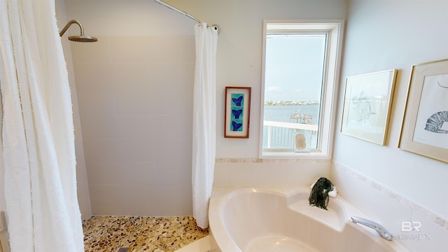 bathroom with a healthy amount of sunlight, a water view, and a shower with curtain