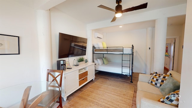 bedroom featuring a wall mounted AC, ceiling fan, and hardwood / wood-style floors