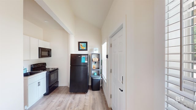 kitchen with black appliances, white cabinets, a healthy amount of sunlight, and light hardwood / wood-style flooring