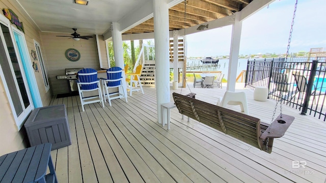 wooden deck featuring ceiling fan and a grill