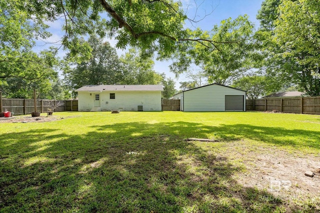 2132 S Pine St, Loxley, AL 36551 - fenced backyard featuring a garage and an outbuilding