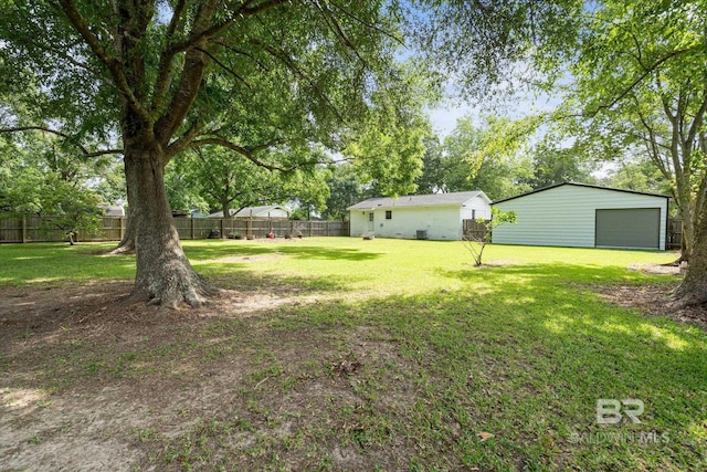 2132 S Pine St, Loxley, AL 36551 - fenced backyard featuring a garage and an outbuilding