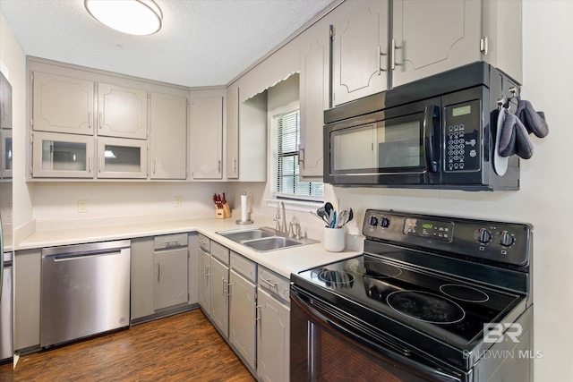 2132 S Pine St, Loxley, AL 36551 - kitchen with black appliances, a textured ceiling, light countertops, dark wood-style floors, and gray cabinets