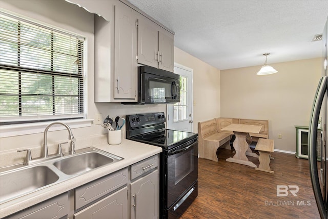 2132 S Pine St, Loxley, AL 36551 - kitchen with black appliances, dark wood-style floors, gray cabinets, light countertops, and decorative light fixtures