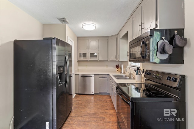 2132 S Pine St, Loxley, AL 36551 - kitchen featuring black appliances, dark wood finished floors, gray cabinets, a textured ceiling, and light countertops