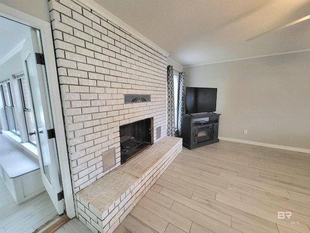 unfurnished living room with light hardwood / wood-style floors, a brick fireplace, and ornamental molding