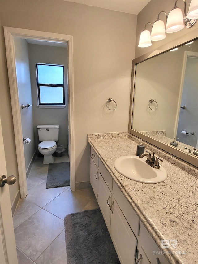 bathroom with tile patterned floors, vanity, and toilet