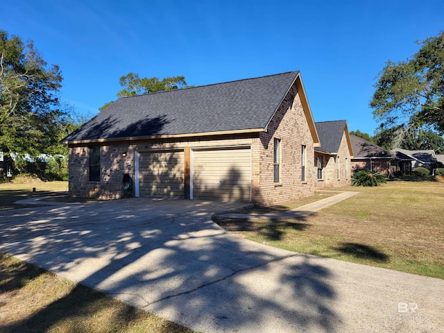 view of side of home featuring a yard and a garage