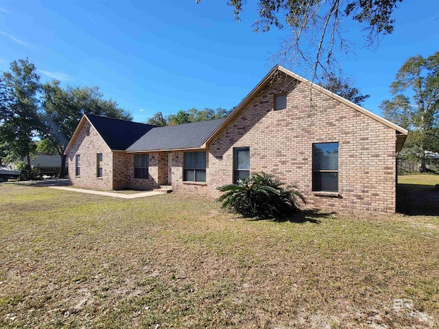 view of side of property with a lawn