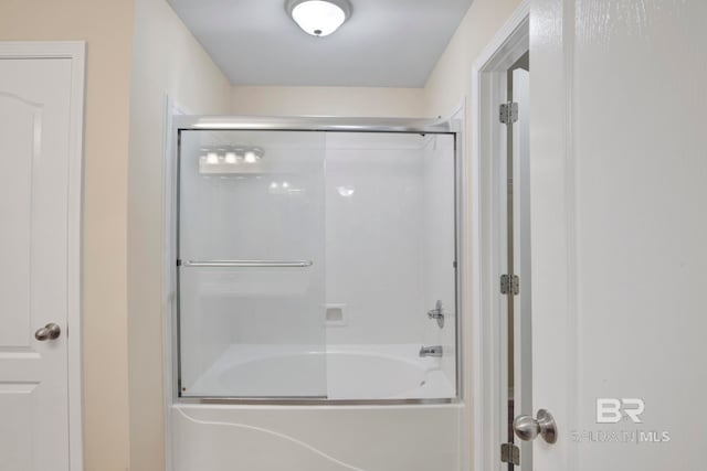 bathroom featuring bath / shower combo with glass door