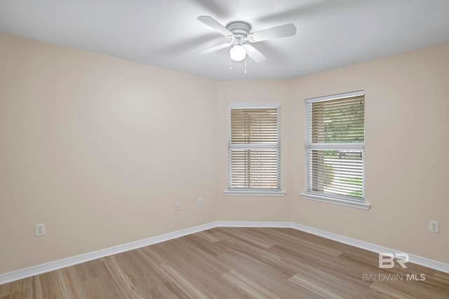 spare room featuring ceiling fan and light hardwood / wood-style floors