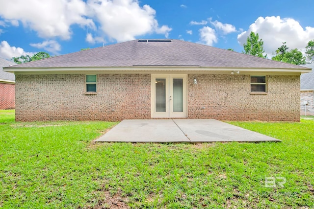 back of house featuring french doors, a patio area, and a lawn