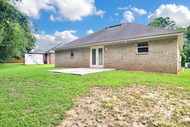 back of property featuring french doors, a yard, cooling unit, and a patio area