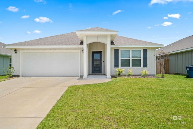 24193 Lanai Ln, Elberta, AL 36530 - ranch-style house featuring a shingled roof, an attached garage, concrete driveway, a front lawn, and board and batten siding