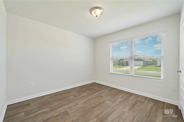 24193 Lanai Ln, Elberta, AL 36530 - empty room featuring dark wood-style flooring and baseboards