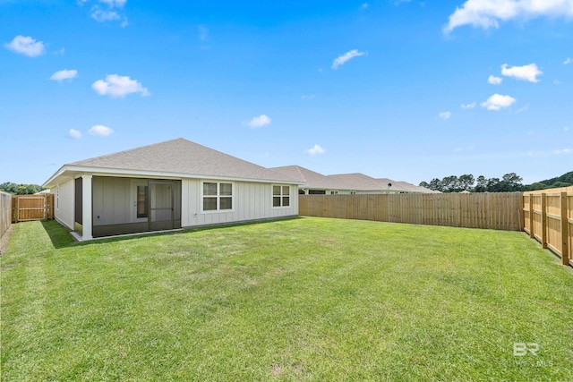 24193 Lanai Ln, Elberta, AL 36530 - back of house with board and batten siding, roof with shingles, and a fenced backyard