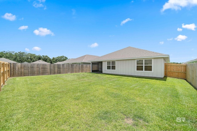 24193 Lanai Ln, Elberta, AL 36530 - back of house with board and batten siding, roof with shingles, and a fenced backyard