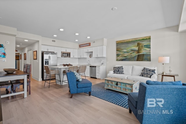 living room with light hardwood / wood-style flooring