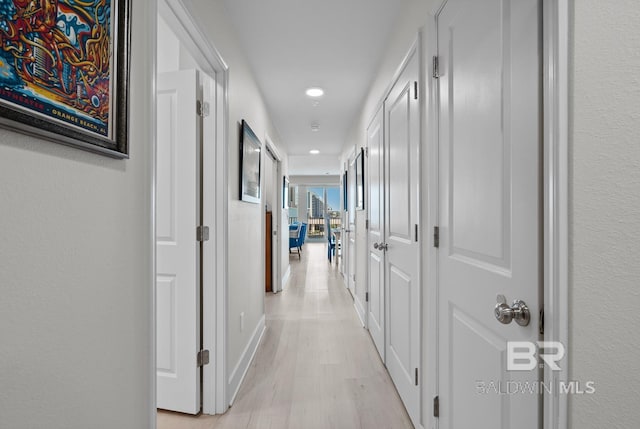 hallway with light wood-type flooring