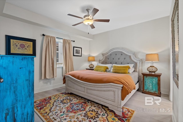 bedroom with light wood-type flooring and ceiling fan