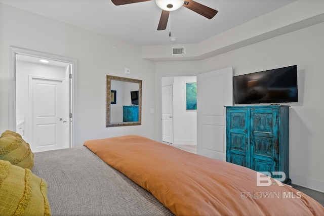 bedroom featuring carpet floors, connected bathroom, and ceiling fan