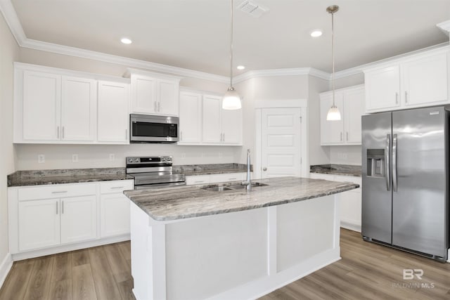 kitchen featuring visible vents, light wood-style flooring, stainless steel appliances, and a sink