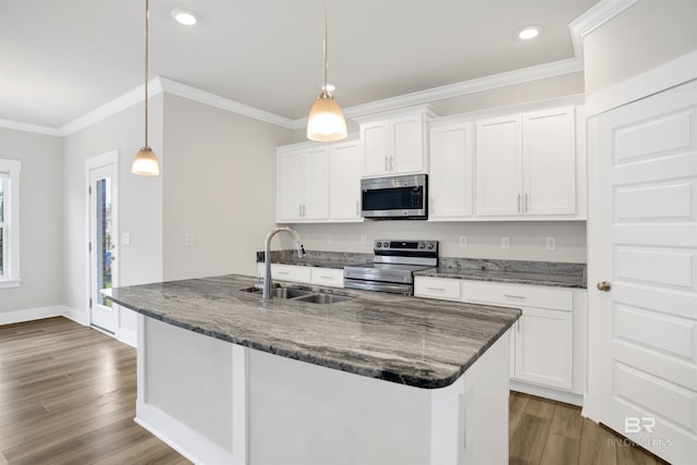 kitchen featuring dark wood finished floors, crown molding, appliances with stainless steel finishes, and a sink