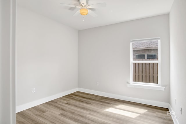 unfurnished room with baseboards, ceiling fan, and wood finished floors