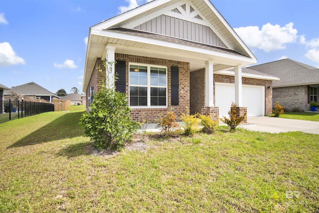 view of front of house with board and batten siding, concrete driveway, an attached garage, a front yard, and brick siding