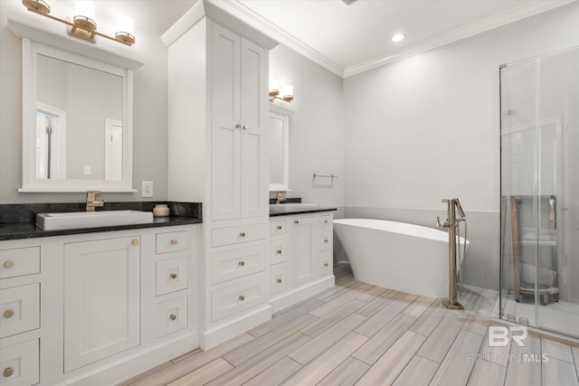 107 Fielding Pl, Mobile, AL 36608 - bathroom featuring crown molding, a stall shower, vanity, a freestanding bath, and recessed lighting