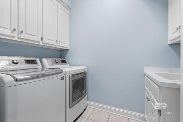 107 Fielding Pl, Mobile, AL 36608 - laundry room with separate washer and dryer, cabinet space, light tile patterned floors, and baseboards