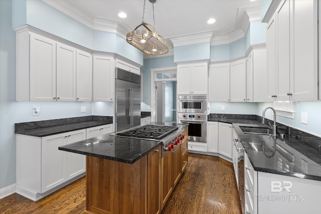 107 Fielding Pl, Mobile, AL 36608 - kitchen with a sink, appliances with stainless steel finishes, dark wood finished floors, a kitchen island, and white cabinetry