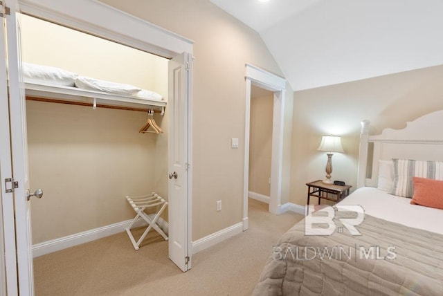 bedroom with lofted ceiling and light carpet