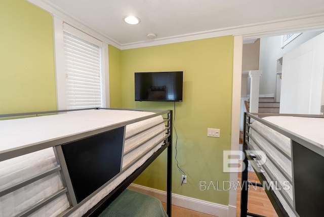 bedroom with crown molding and wood-type flooring