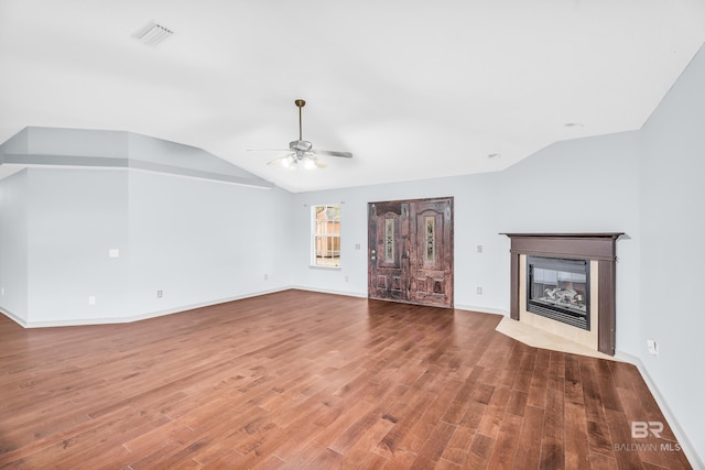 unfurnished living room featuring ceiling fan, wood-type flooring, and lofted ceiling