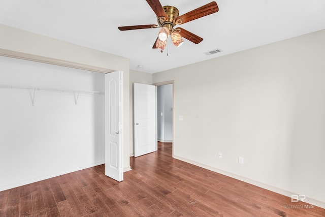 unfurnished bedroom featuring ceiling fan, a closet, and hardwood / wood-style flooring