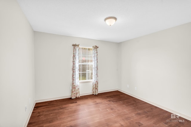 empty room featuring wood-type flooring