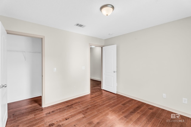 unfurnished bedroom with a closet and wood-type flooring