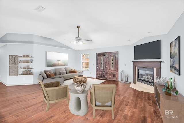 living room featuring hardwood / wood-style floors, ceiling fan, and lofted ceiling