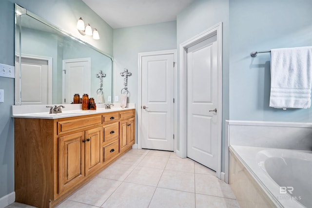 bathroom with double vanity, a garden tub, a sink, and tile patterned floors